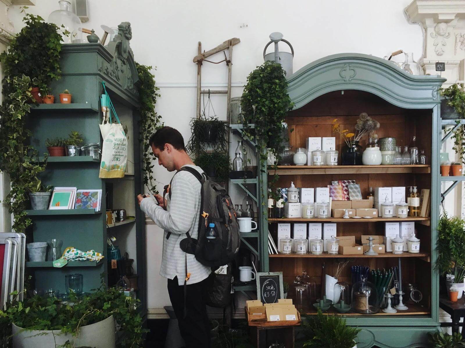 Multi Channel Inventory Sync: A photo shows a beautiful boutique with plants, handmade cards, candles, and miscellaneous goods for your home.
